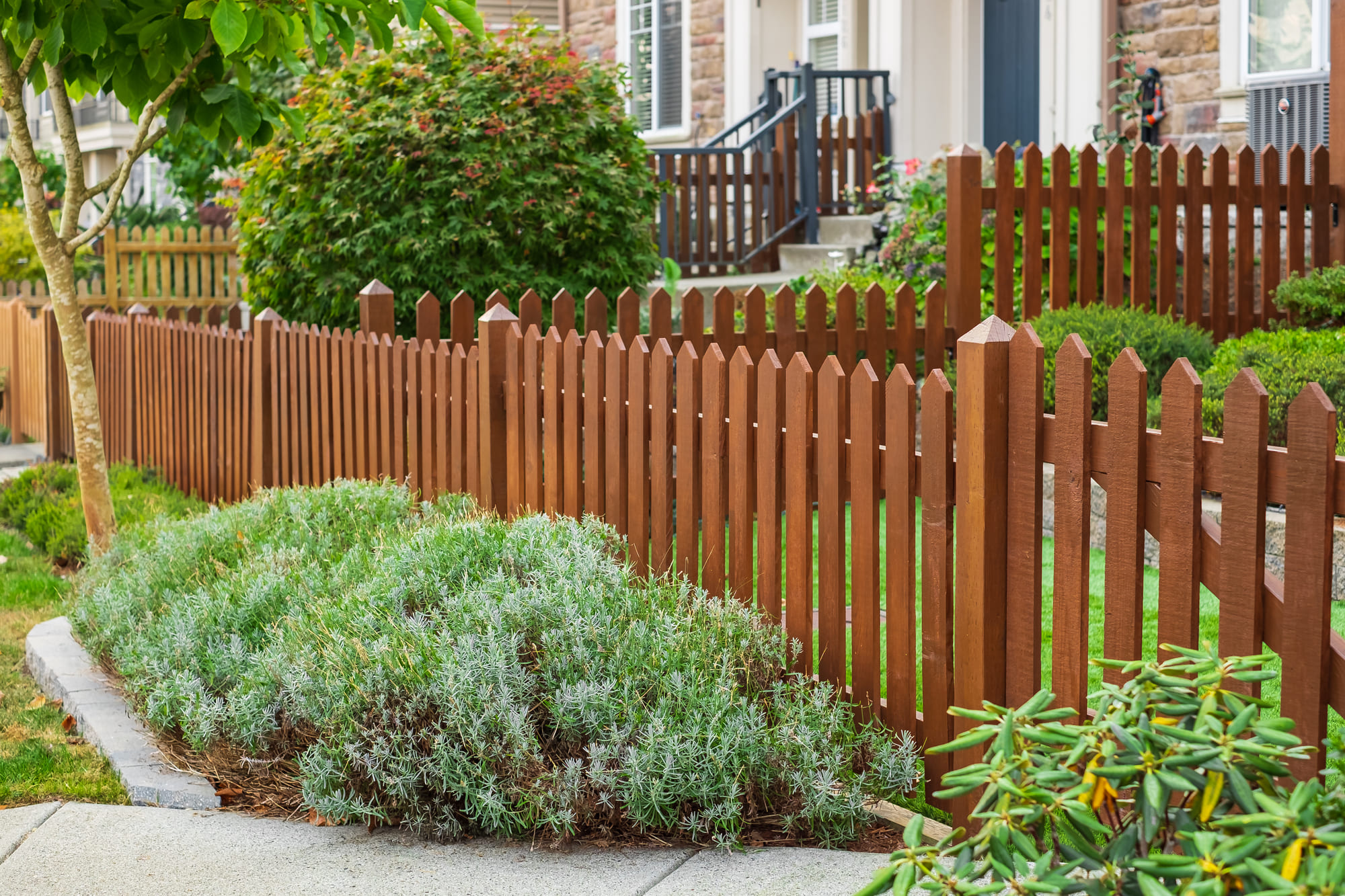 brown stained wood picket fence