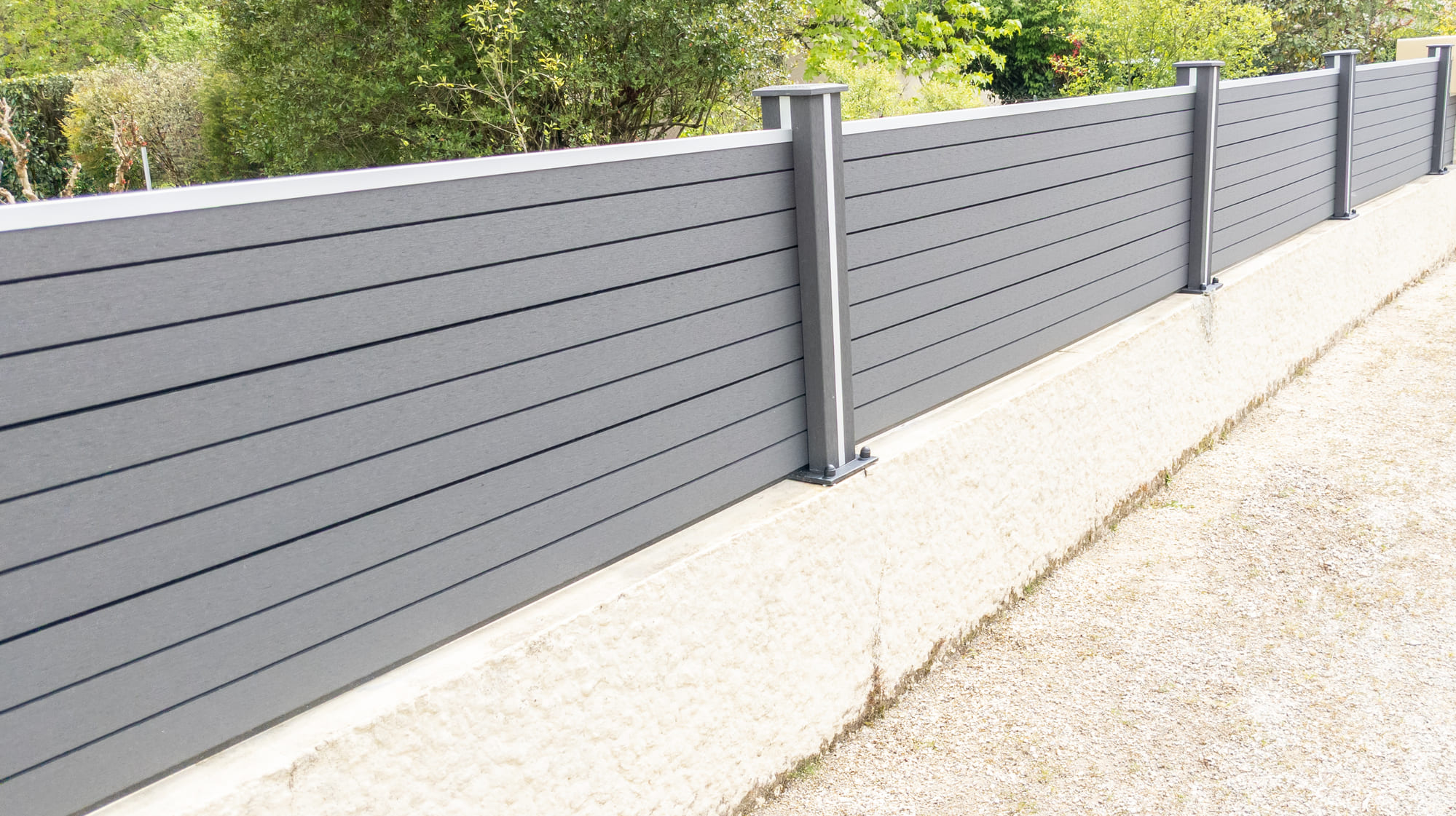 A grey aluminum aesthetic fence of a suburban house